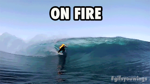 Surfer on fire riding wave
